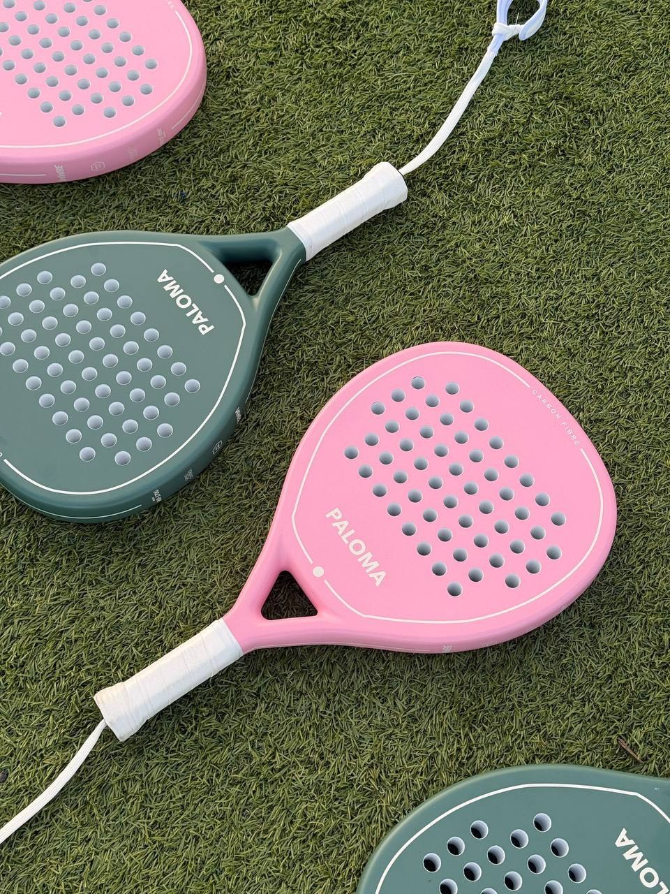Paloma Pink and Ivory Green padel rackets on artificial grass